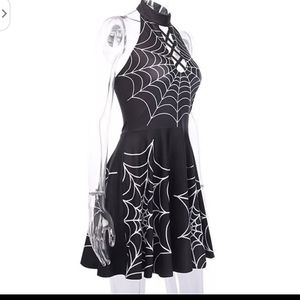 Cute little black dress with spiderweb design.